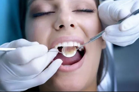 woman getting her  teeth cleaned