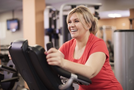 Woman working out and smiling because she had her teeth treated at Northwest Dental Group