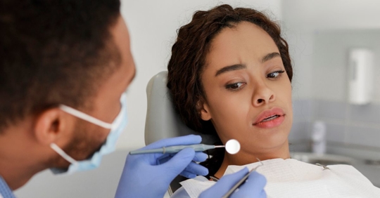 Young woman is nervous in a dental office.